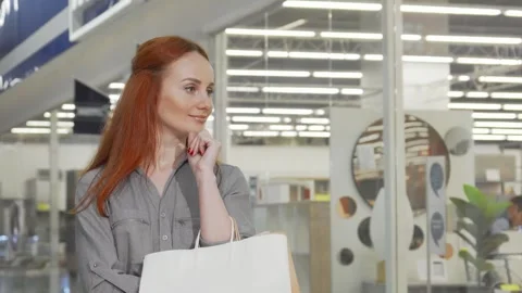Cheerful woman smiling to the camera while shopping at the mall Video stock 311985487