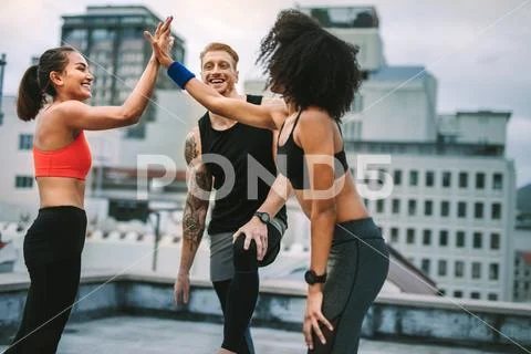 Cheerful women athletes giving high five after workout Stock Photos