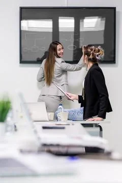 Cheerful women drawing an algorithm Young female colleagues drawing an alg... Stock Photos