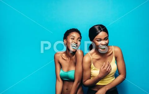 Cheerful women standing together and laughing Stock Photos