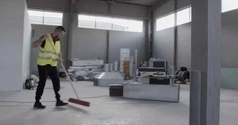 A cheerful worker dances with the sweeper while cleaning the deposit. Stock Footage 127203291