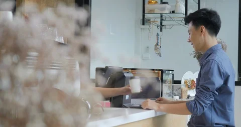 Cheerful worker serving a customer coffee to go Stock Footage 92217323
