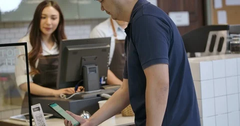 Cheerful worker serving a customer coffee to go Stock Footage 118102980