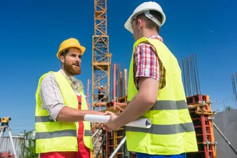 Cheerful worker shaking the hand of an architect Stock Photos