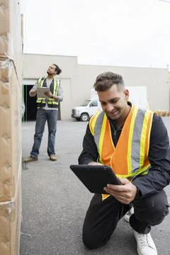 Cheerful worker using digital tablet on warehouse yard Stock Photos
