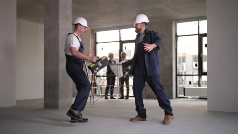 Cheerful workers dancing during renovation work Stock Footage 149073005