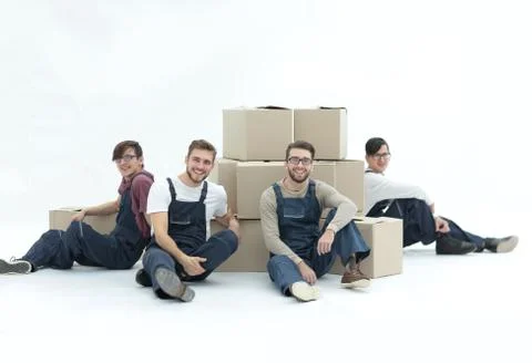 Cheerful workers with stacked boxes isolated on white. Stock Photos