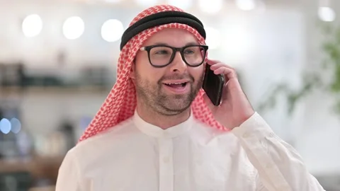Cheerful Young Arabic Man Talking on Smartphone Stock Footage 139775988