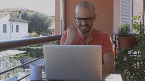 Cheerful Young Boy Types on his Laptop, Celebrates Success Stock Footage 126613081