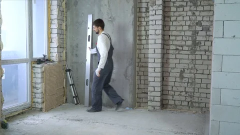 Cheerful young builder with construction ruler imitates guitar playing Stock Footage 106126389