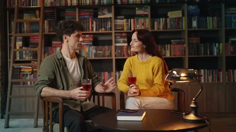Cheerful young couple drinking wine and talking during romantic cafe date Stock Footage 340266679