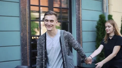 Cheerful young couple walks around the city Stock Footage