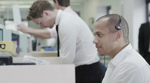 Cheerful young customer service operator, at work in a busy call center Stock Footage 25755440