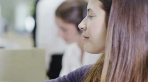 Cheerful young customer service operator, at work in a busy call center Stock Footage 25769949