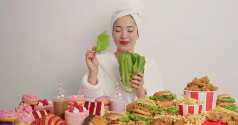 Cheerful young female model has balanced nutrition refuses eating junk food eats Stock Footage 155491225