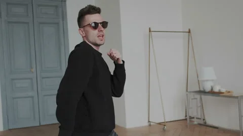 Cheerful young guy is dancing in euphoria. He dancing modern cool choreography Stock Footage 107814399
