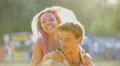 Cheerful young lady jumping on man's back, taking friend by surprise, friendship 4k or 4k+ Resolution