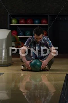 Cheerful young man holding bowling ball Stock Photos