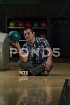 Cheerful young man holding bowling ball Stock Photos
