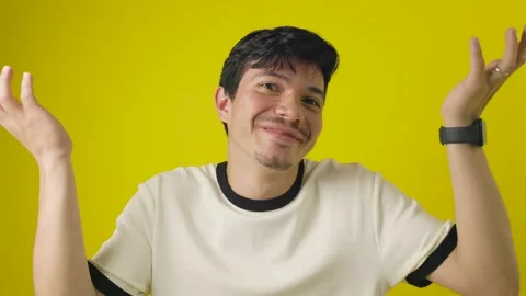 Cheerful young man making questioning expression with his hands Stock Footage 312815186