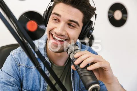 Cheerful young man radio host broadcasting Stock Photos