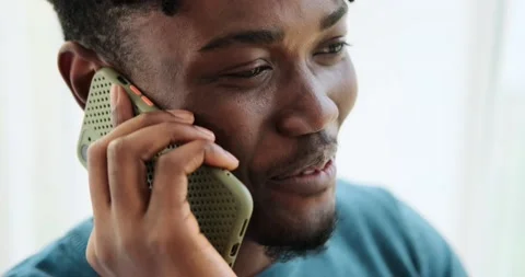 Cheerful young man talking on mobile phone Video stock 156543814