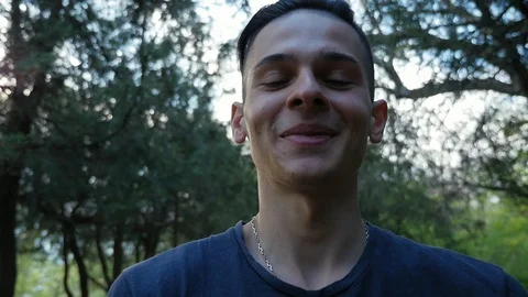 Cheerful young man walking with camera in the hand and filmimg yourself  in the Stock Footage 108344039