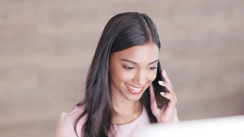 Cheerful young receptionist scheduling appointments and confirming meetings with Stock Footage