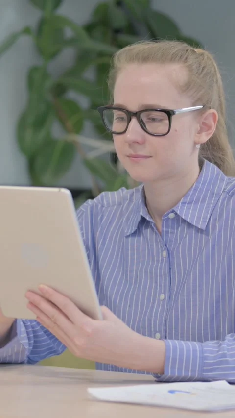 Cheerful Young Woman using Tablet PC, vertical video 動画素材 328549122