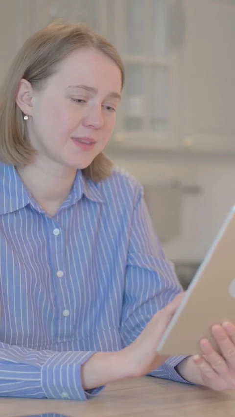 Cheerful Young Woman using Tablet Computer, vertical video Video stock 328564327