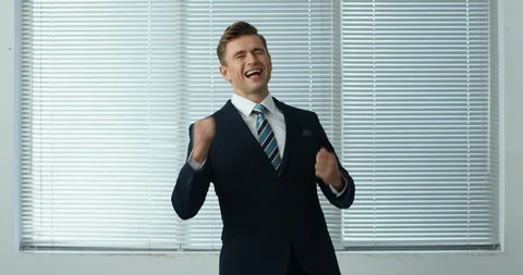Cheering Businessman standing by the window Stock Footage 100949480