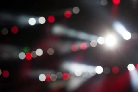 Cheering crowd in front of bright stage lights Stock Photos