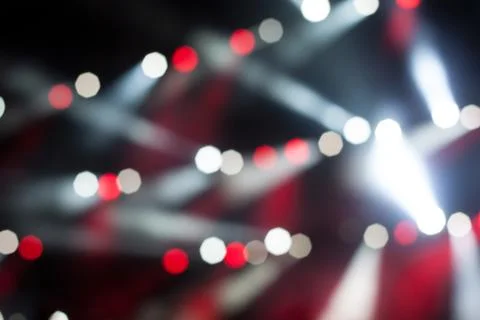 Cheering crowd in front of bright stage lights Stock Photos