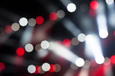 Cheering crowd in front of bright stage lights Stock Photos