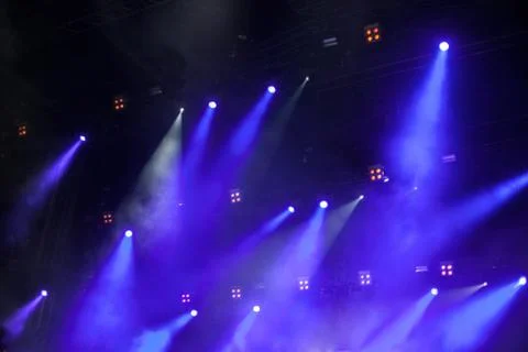 Cheering crowd in front of bright stage lights Stock Photos