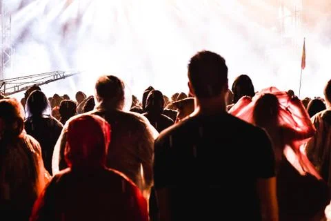 Cheering crowd in front of bright stage lights Stock Photos