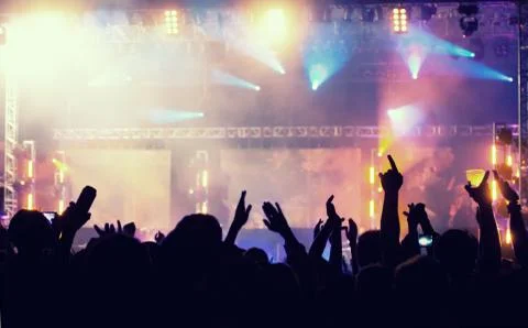 Cheering crowd in front of stage lights - retro photo Stock Photos