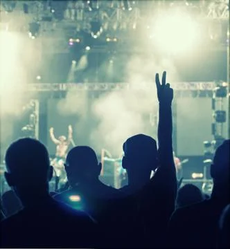 Cheering crowd in front of stage lights - retro photo Stock Photos