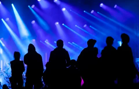 Cheering crowd in front of stage lights Stock Photos