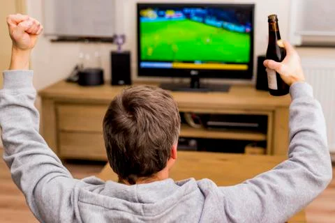 Cheering in front of tv Stock Photos