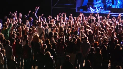 Cheering spectators audience clapping hands up in air on rock concert Stock Footage