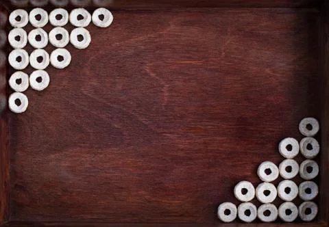 Cheerios lined as two angles into dark wood box Stock Photos