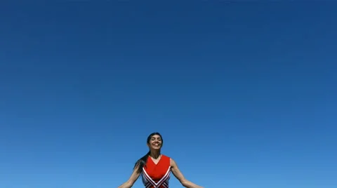 Cheerleader flies into air and does splits, slow motion Stock Footage 61669596