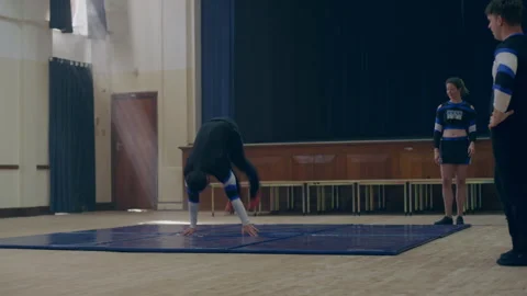 Cheerleaders doing a warm up training with a backflip Stock Footage 279768280