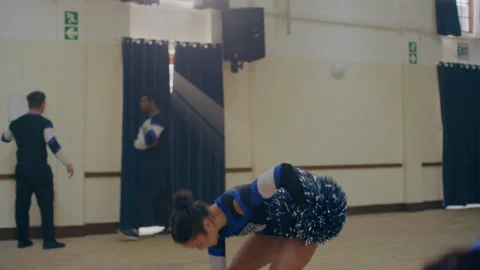 Cheerleaders practicing before a match using pom poms Stock Footage 279751598