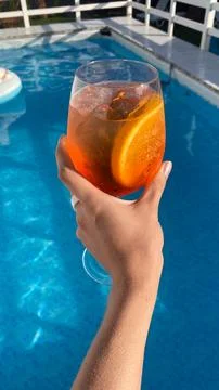 Cheers to a refreshing drink by the pool on a sunny day with a hint of citr.. Stock Photos