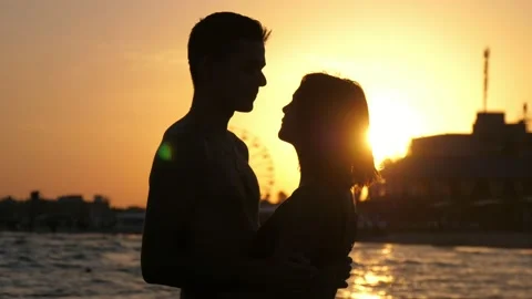 Cheery couple hugging, smiling to each other in river waters at sunset in slo-mo Stock-Footage 135231341