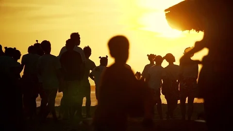 Cheery crowd walking along seashore with boxes and balloons in Vietnam in slo-mo Stock Footage 98451229