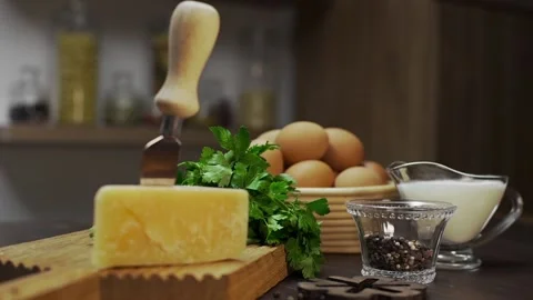 Cheese and eggs are on the kitchen table ingredients for cooking omelette Stock Footage 143592437