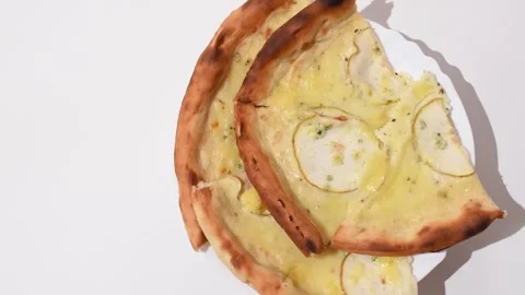 Cheese and pear pizza turning around on white background,horizontal video, top  Stock Footage 339631853